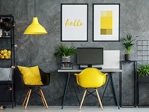 Industrial_chic_study_concrete_effects_wall_bold_yellow_chair_pillow_lamp_artwork_green_plant_shelf